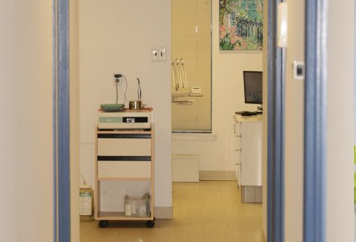A hallway in a dentist office with a warm and welcoming color grade.